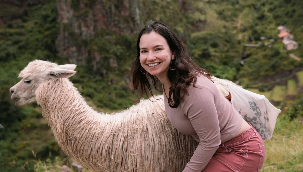 Female tourist with a llama | Ultimate Trekking