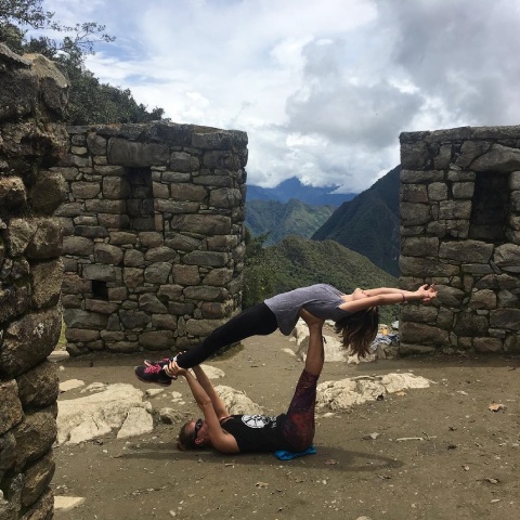 Two travelers practicing yoga at the Sun Gate Machu Picchu | Ultimate Trekking