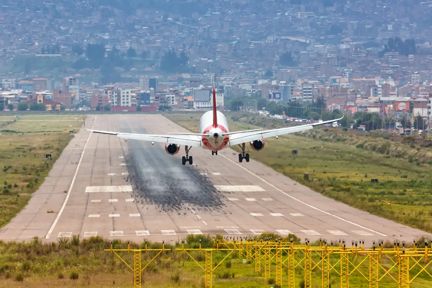 Airplane landing at Cusco airport runway | Ultimate Trekking