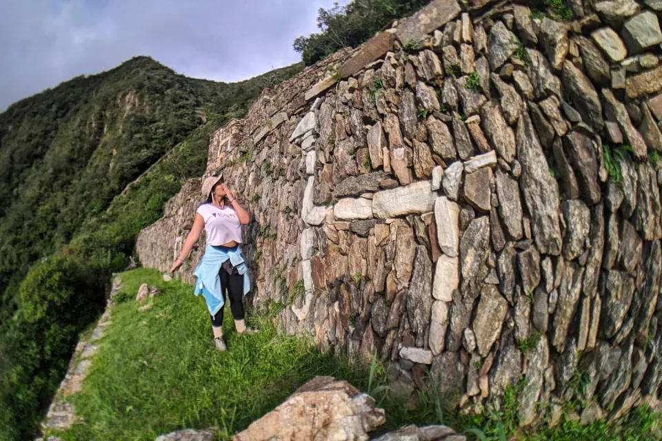 Tourist admiring one of the llama figures on one of the walls of the Choquequiro llamas | Ultimate Trekking