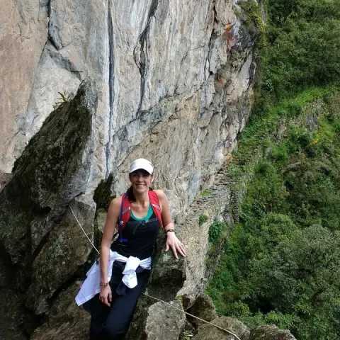 Tourist posing at the Inca bridge of Machu Picchu | Ultimate Trekking