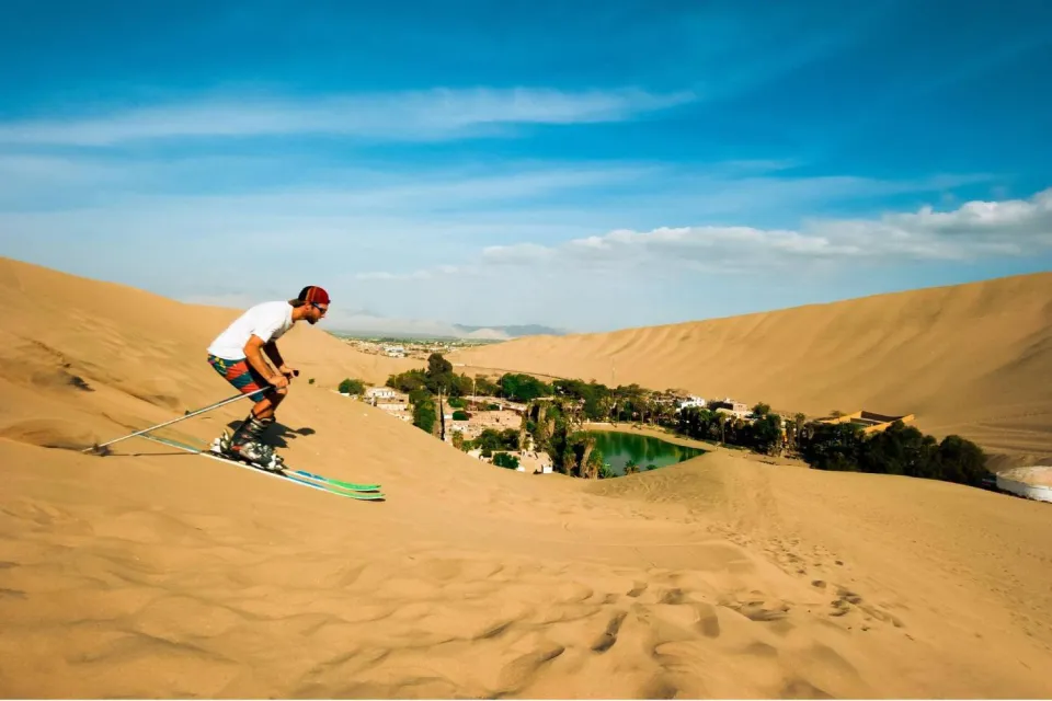 Tourist Sandboarding near the Huacachina Lagoon | Ultimate Trekking
