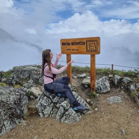 Young lady on top of Machu Picchu mountain | Ultimate Trekking