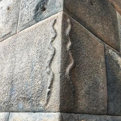 Inca wall with carved snakes  | Ultimate Trekking