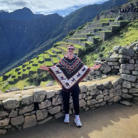Boy posing with the agricultural terraces of Machu Picchu | Ultimate Trekking