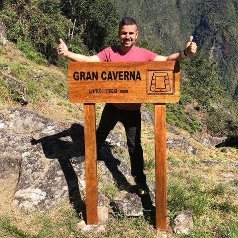 Boy climbing the great cavern of Machu Picchu | Ultimate Trekking