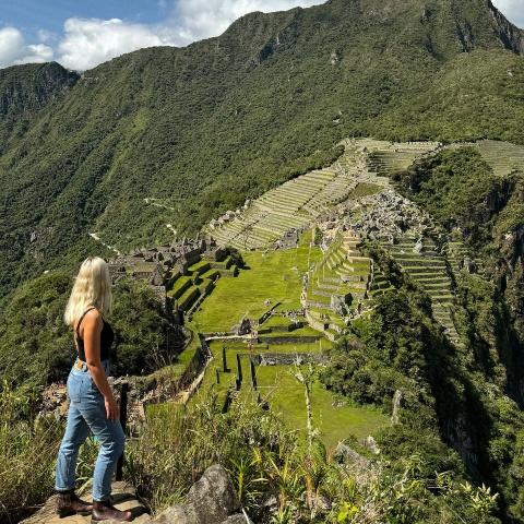 tourist taking photo on the hike to Huchuy Picchu mountain | Ultimate Trekking