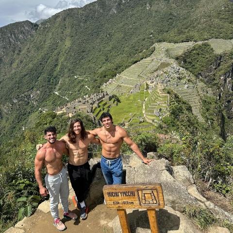 boys posing at the Huchuy Picchu mountain viewpoint | Ultimate Trekking