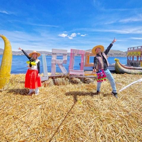 Tourists taking a selfie at the Uros cartes on Uros Island | Ultimate Trekking