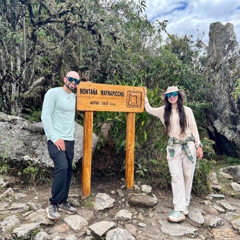 Tourist posing on Machu Picchu mountain | Ultimate Trekking