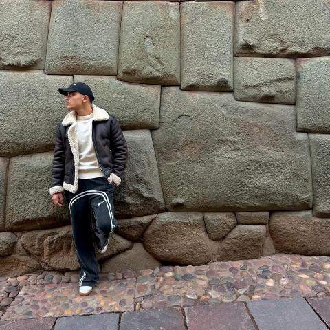 Tourist taking a photo with the 12-angled stone | Ultimate Trekking