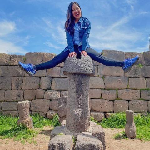 tourist on top of one of the sculptures of the temple of fertility | Ultimate Trekking